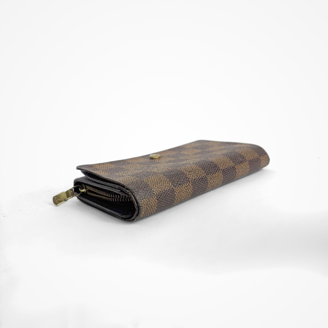 Brown checkered LV wallet with gold accents on a white background