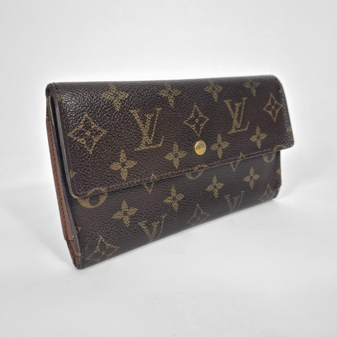 Louis Vuitton wallet with monogram pattern on a white background