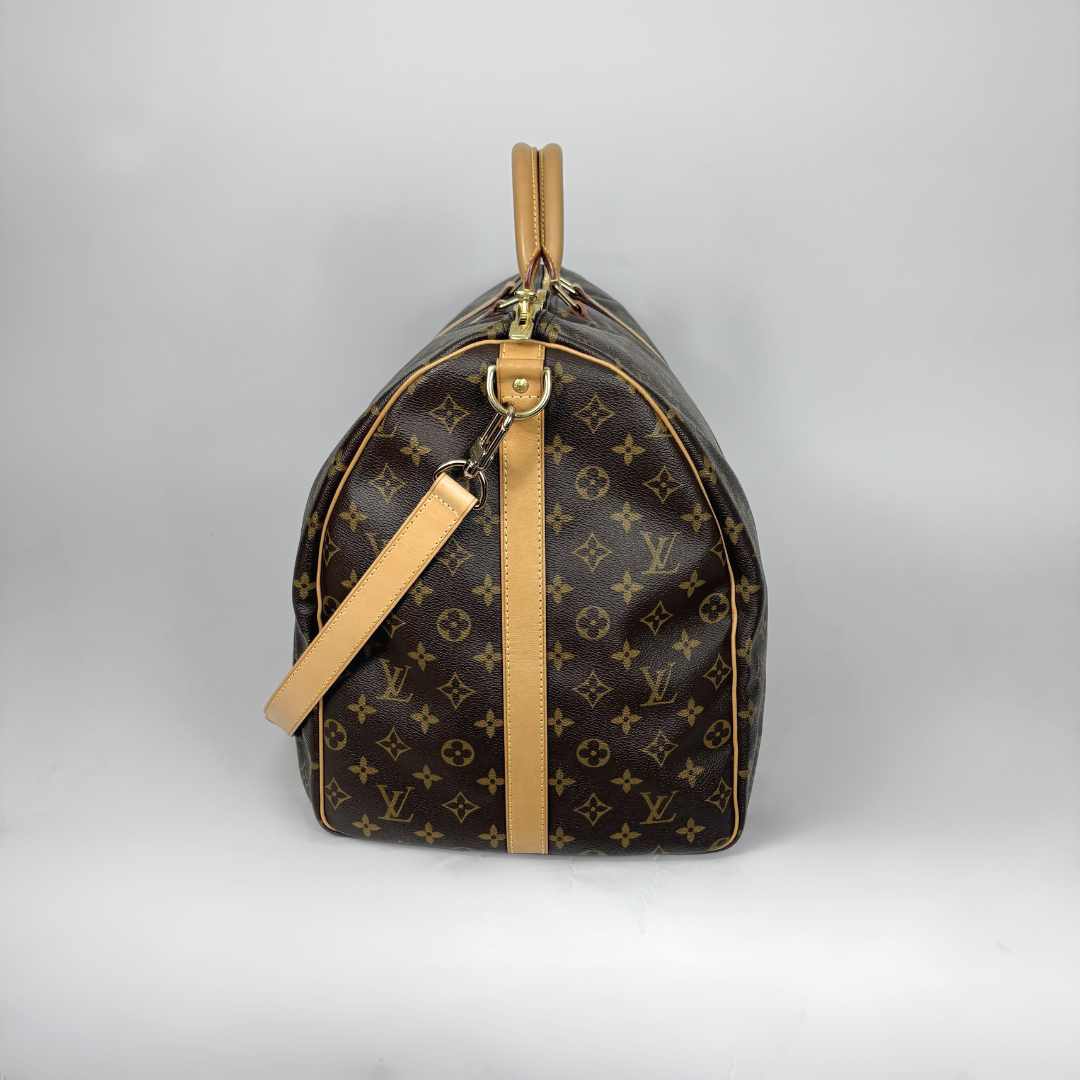 Designer handbag with monogram pattern on a light gray background