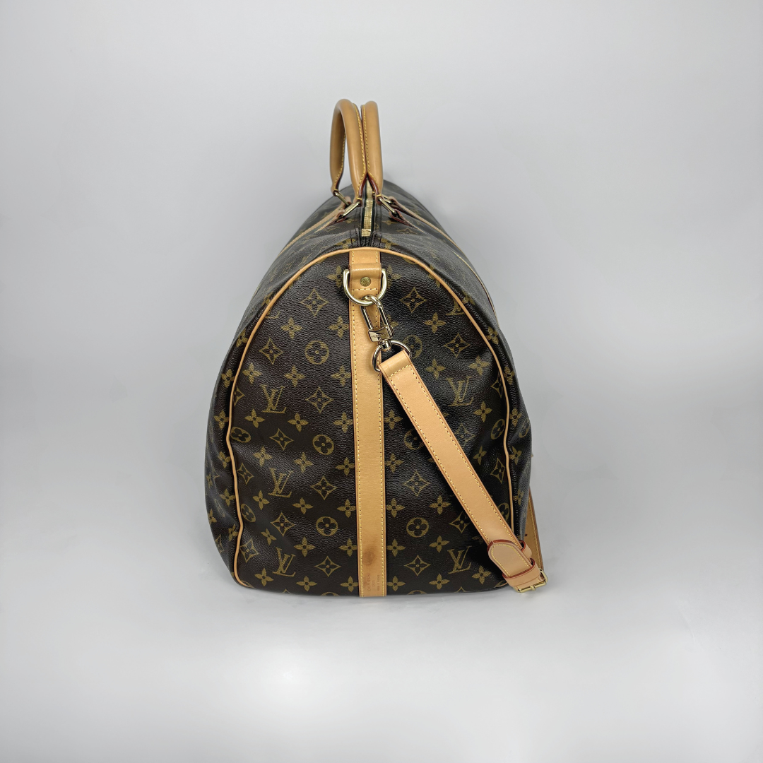 Louis Vuitton monogram handbag with tan leather accents on a light gray background