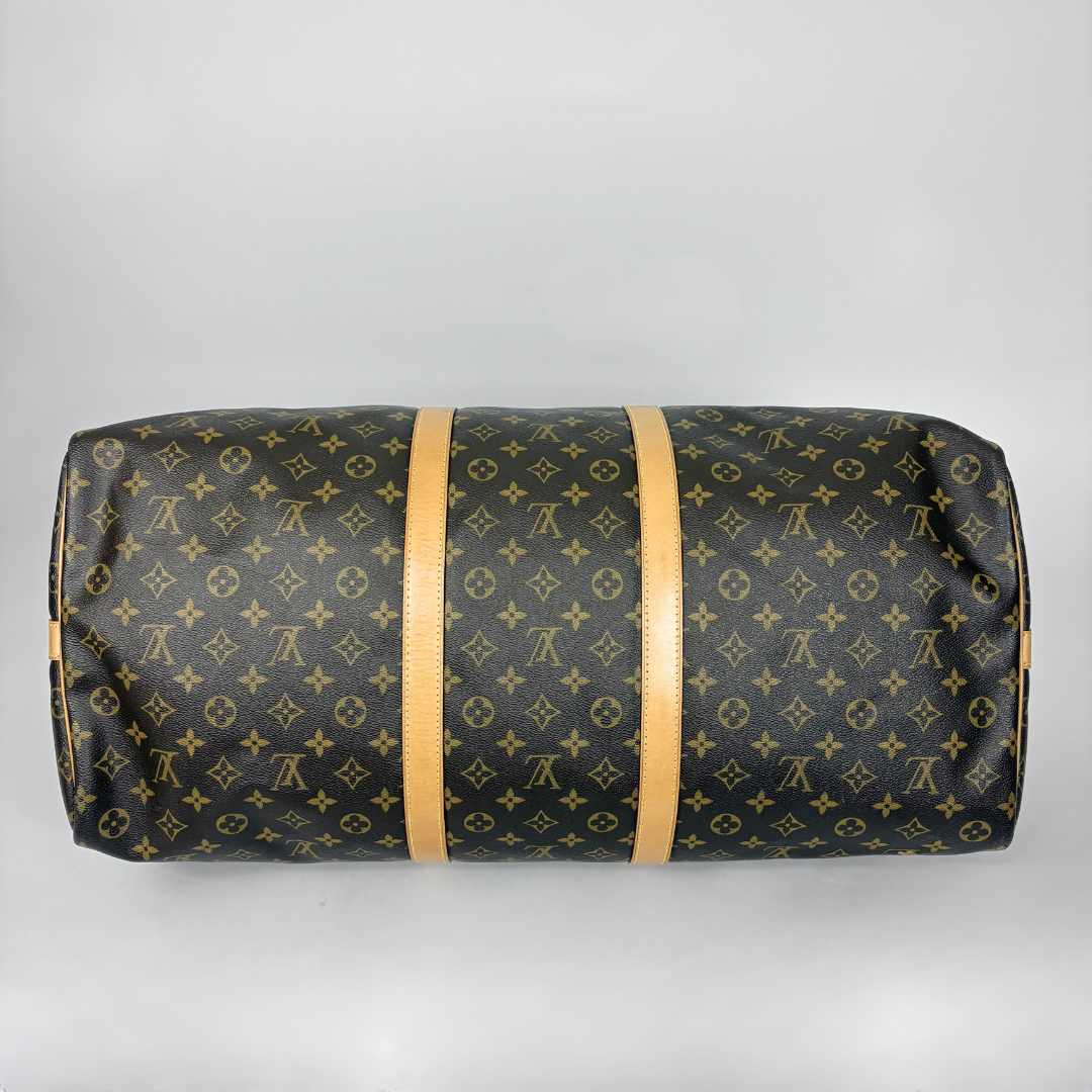 Louis Vuitton monogram duffel bag on a light gray background