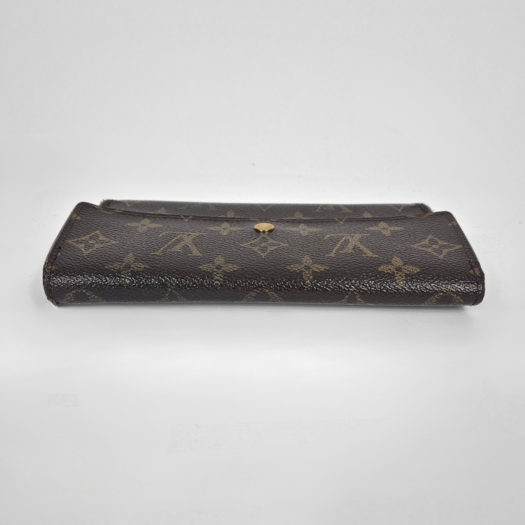 Louis Vuitton monogram clutch bag on a light gray background