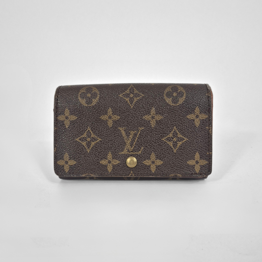 Louis Vuitton wallet with monogram pattern on a white background