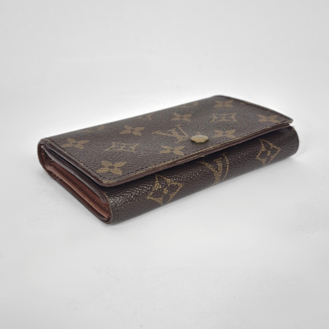 Brown wallet with monogram pattern on a white background
