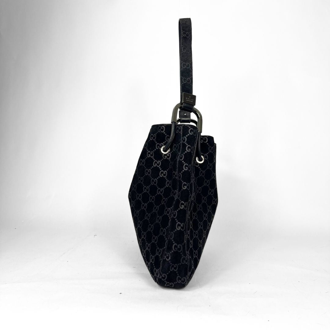 Black handbag with a pattern on a white background