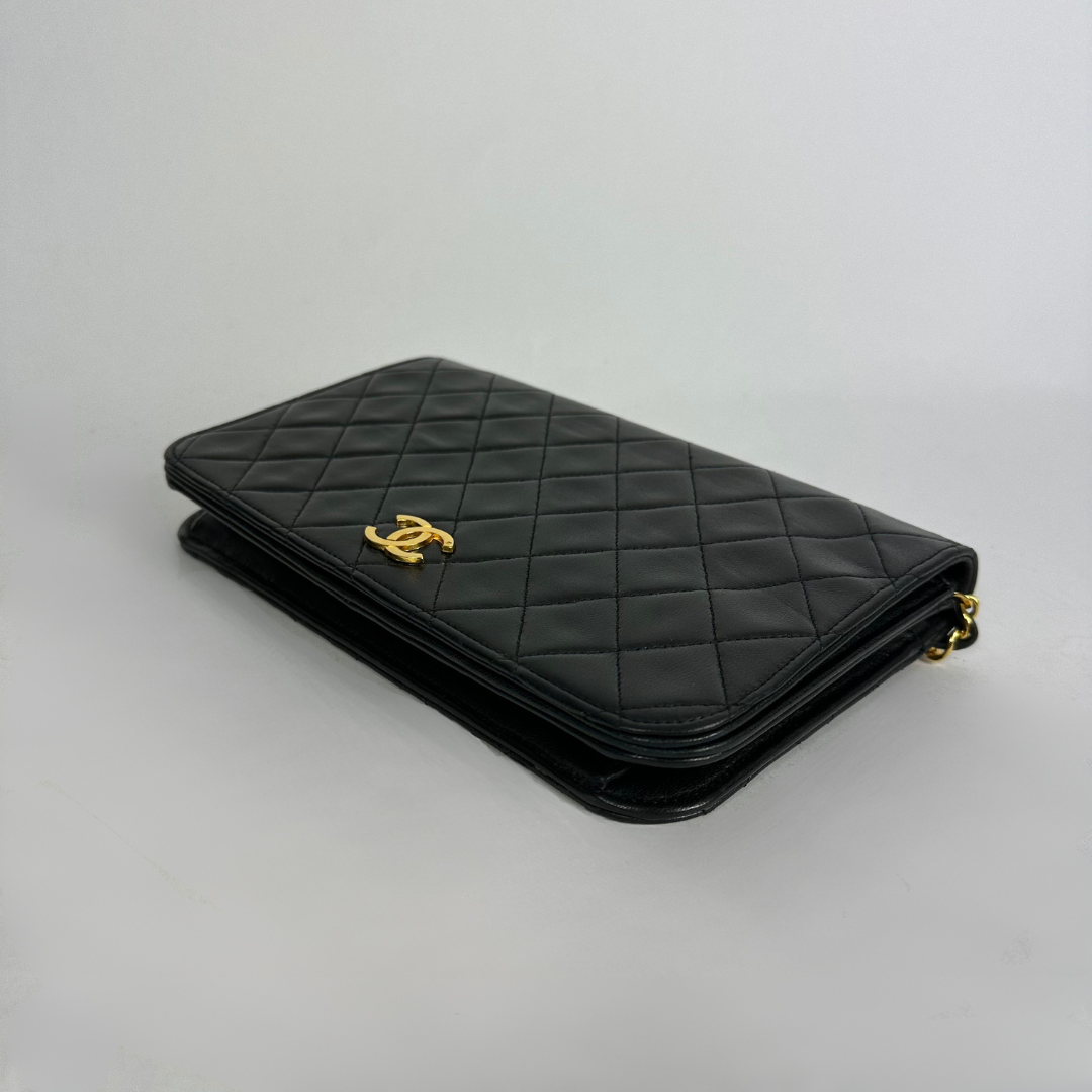 Black Chanel bag on white background