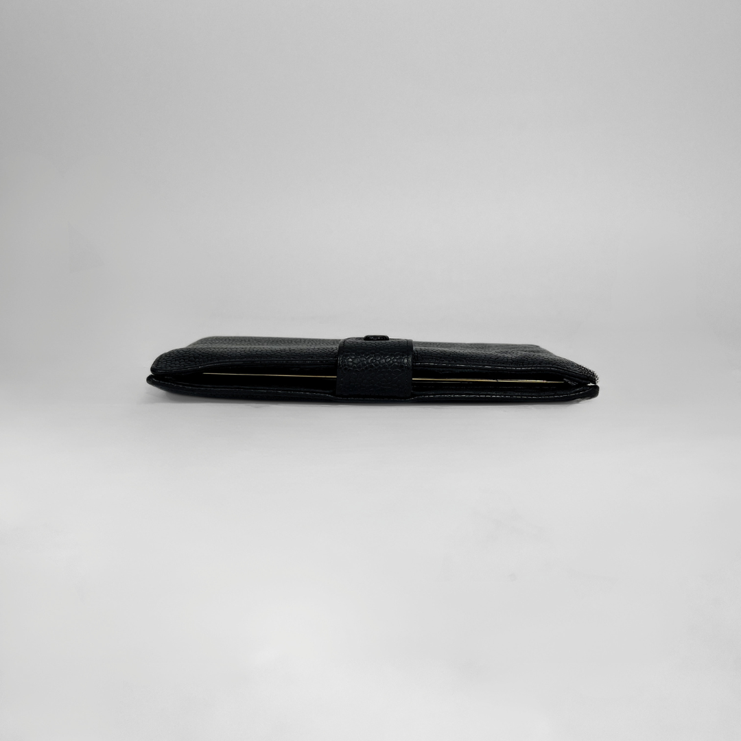 A black textured leather wallet shown closed in a horizontal orientation on a light gray studio background.