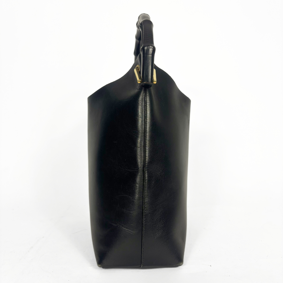 Gucci vintage black leather hobo hag with a dark wood bamboo top handle and gold-tone hardware.