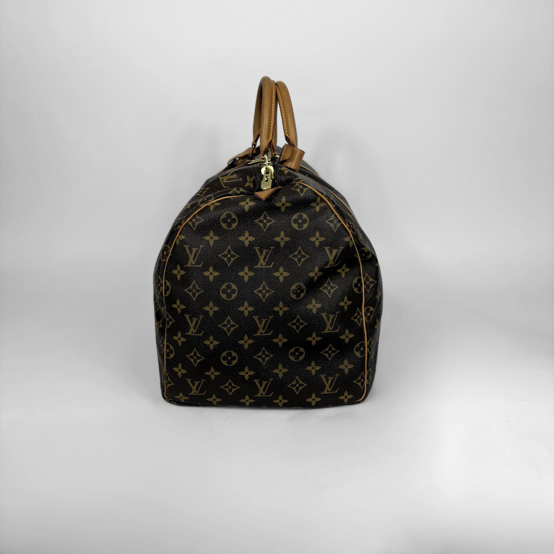 Designer handbag with monogram pattern on a white background