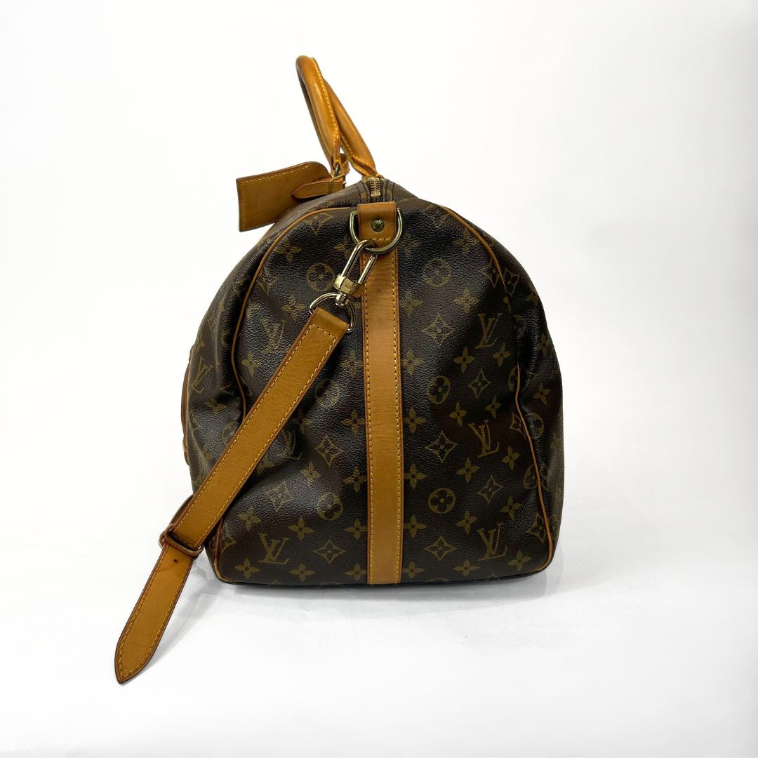 Brown monogram handbag with tan leather accents on a white background