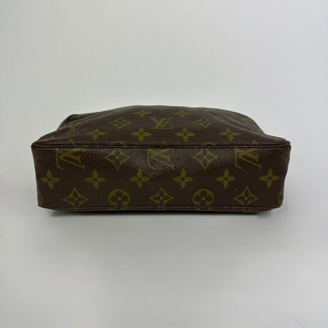 Louis Vuitton toiletry bag in front of white background