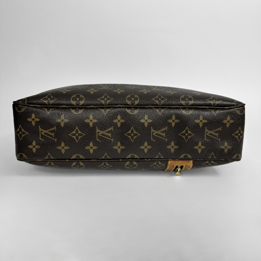Louis Vuitton monogram handbag on a light gray background