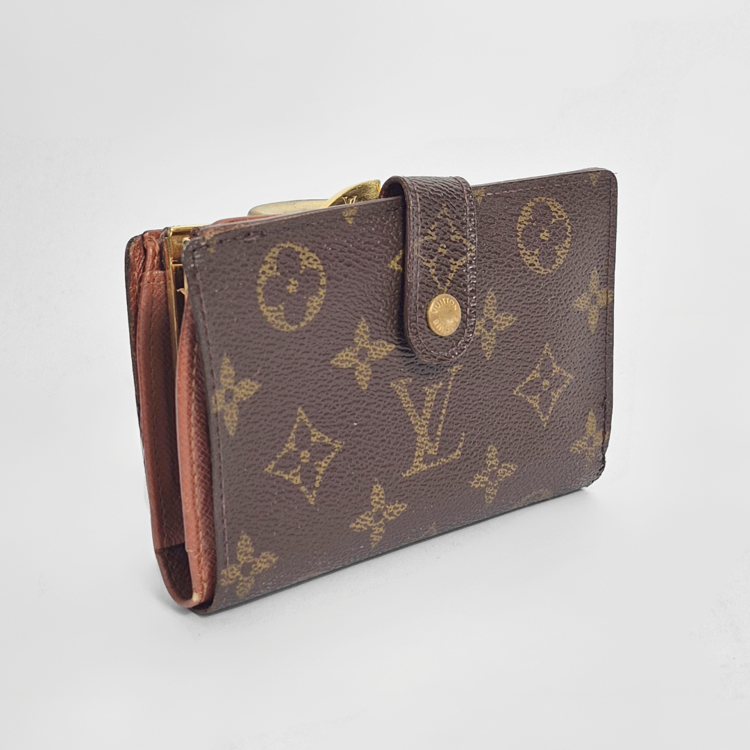 Brown leather wallet with gold accents on a light gray background