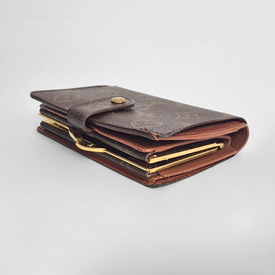 Brown leather wallet with gold accents on a light gray background