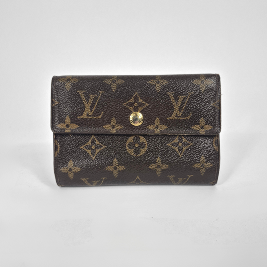 Louis Vuitton wallet with monogram pattern on a white background