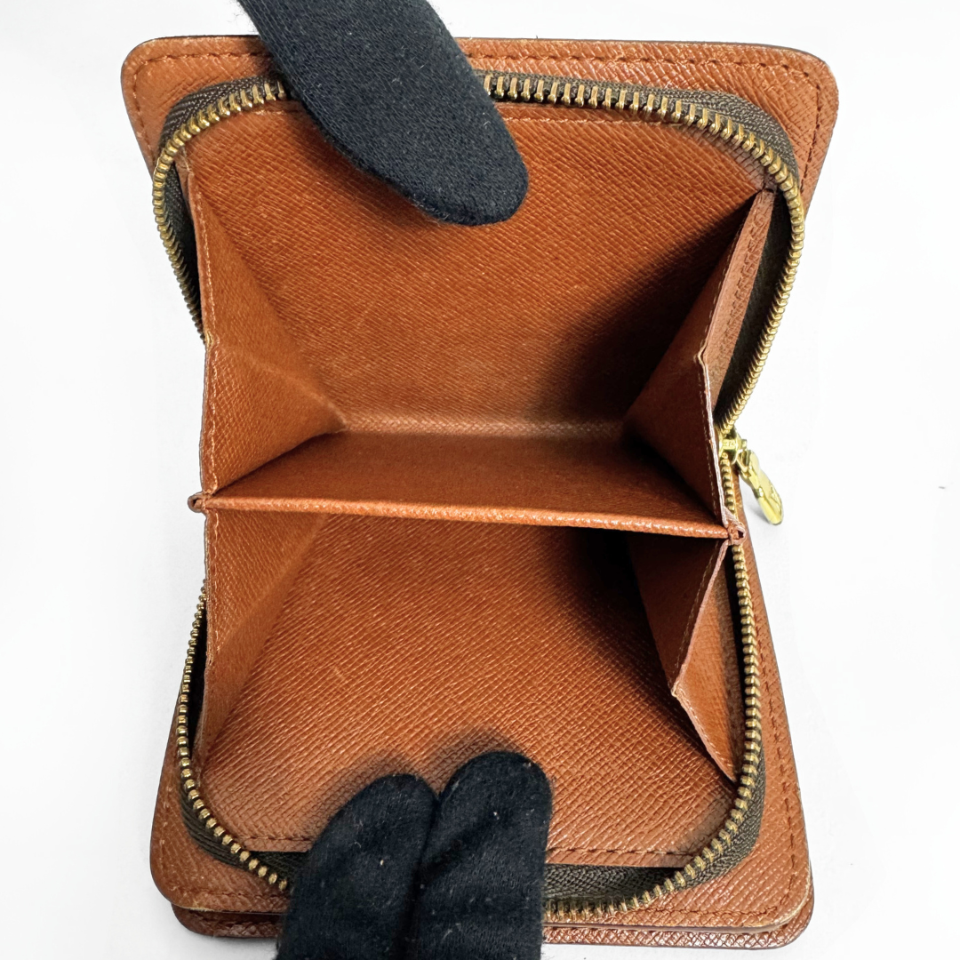 Brown leather wallet with gold zipper on a white background