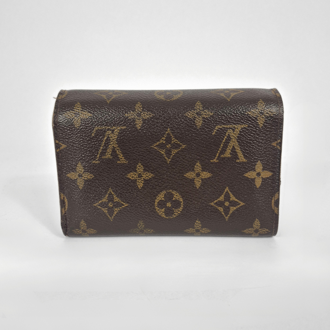 Brown leather wallet with gold monogram pattern on a white background
