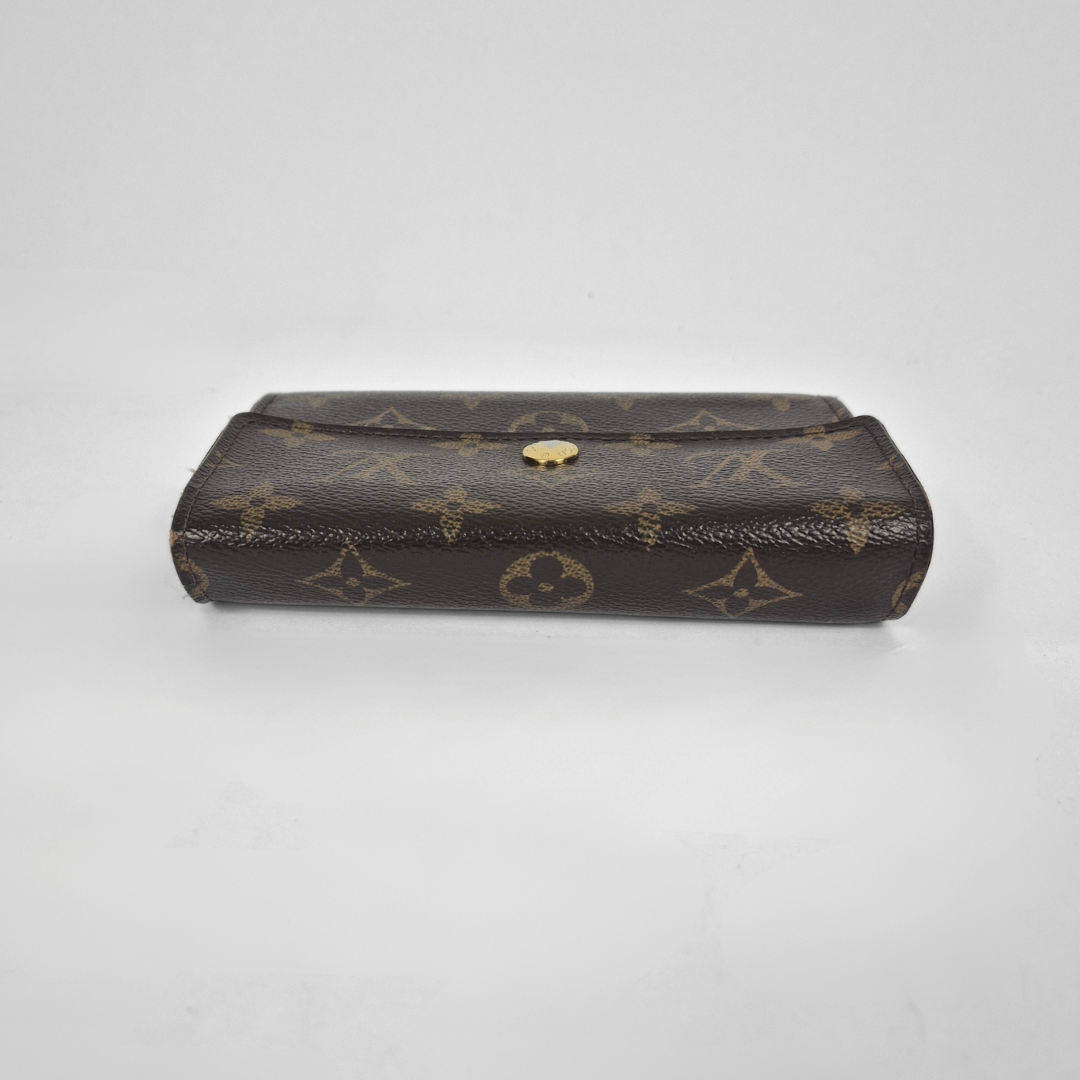 Louis Vuitton monogram clutch on a light gray background