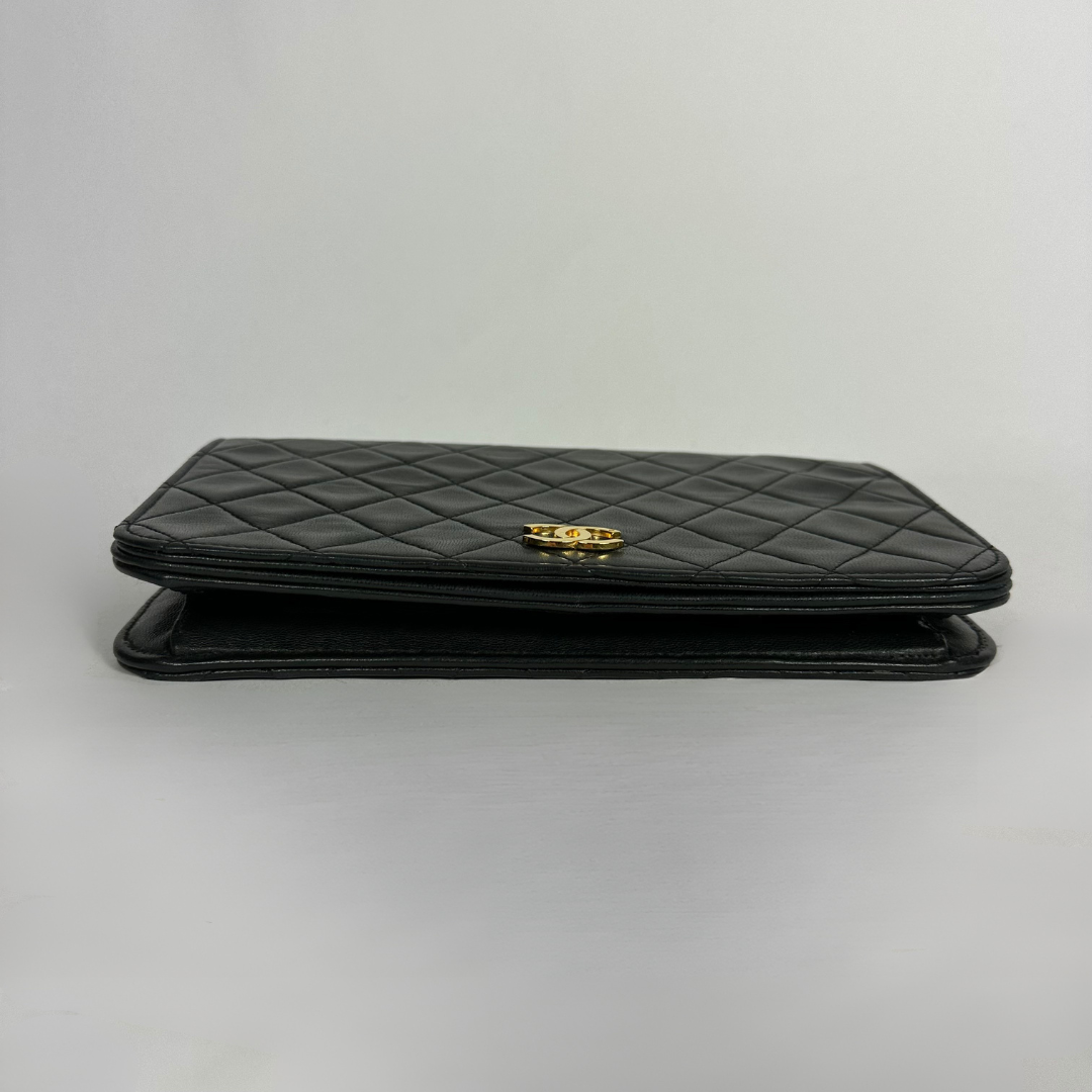 Black Chanel bag on white background