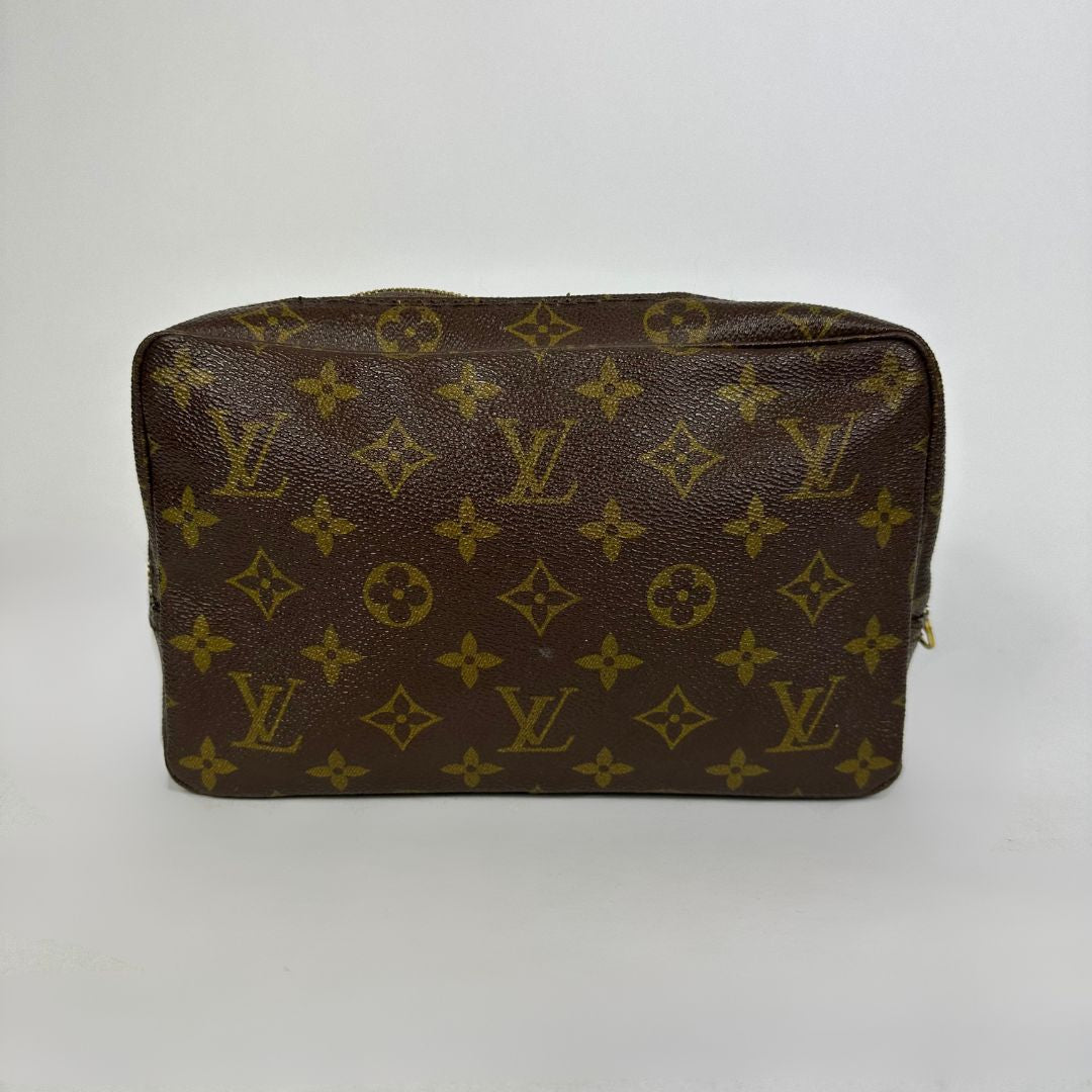 Louis Vuitton toiletry bag in front of white background