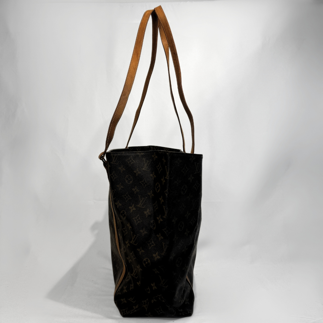 A Louis Vuitton monogram canvas tote bag with tan leather shoulder straps, photographed against a white studio background.