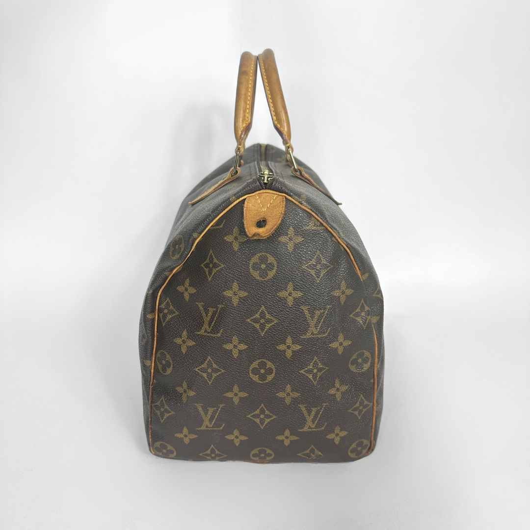 Brown handbag with a monogram pattern on a white background