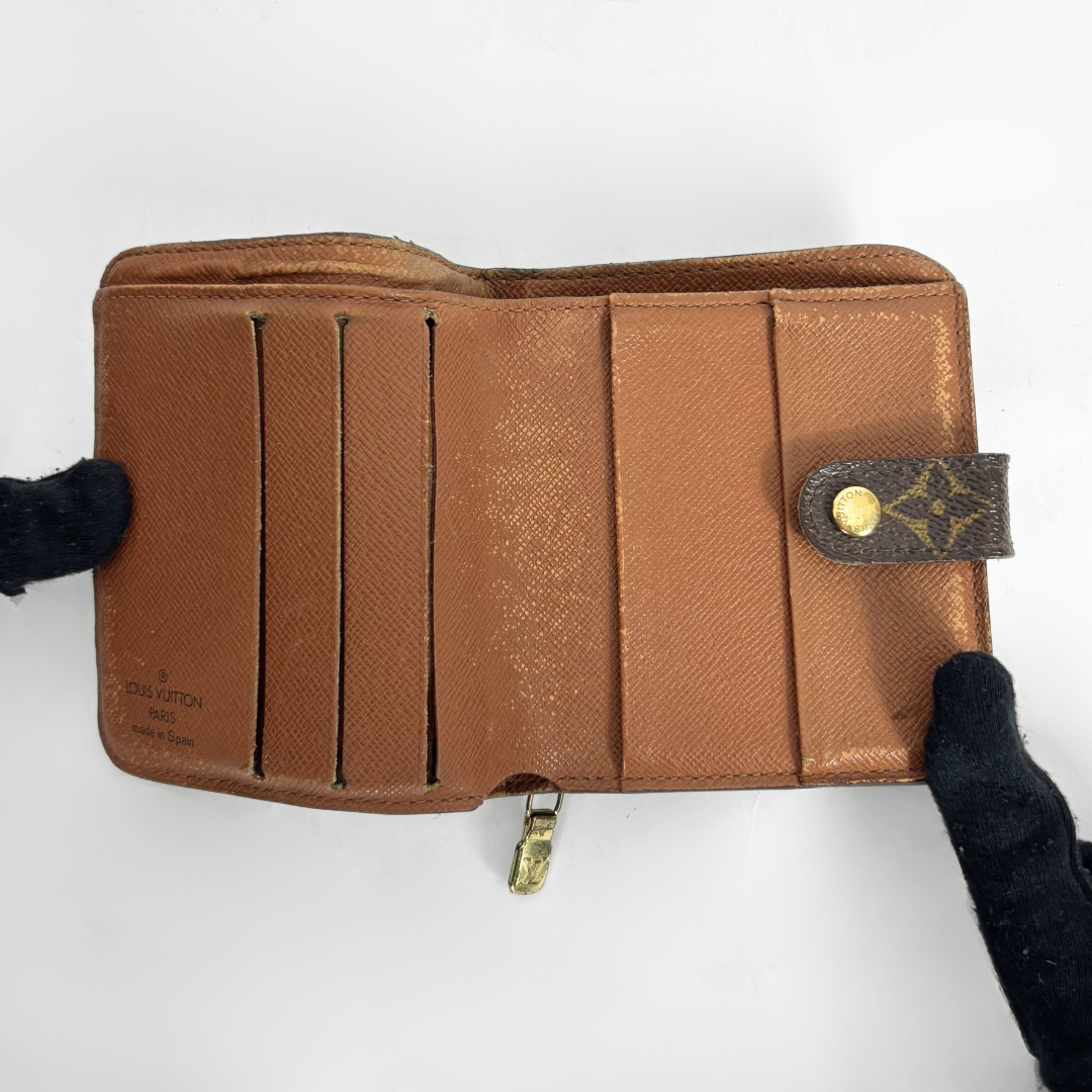 LV compact wallet in signature brown monogram canvas with a snap-button strap closure.