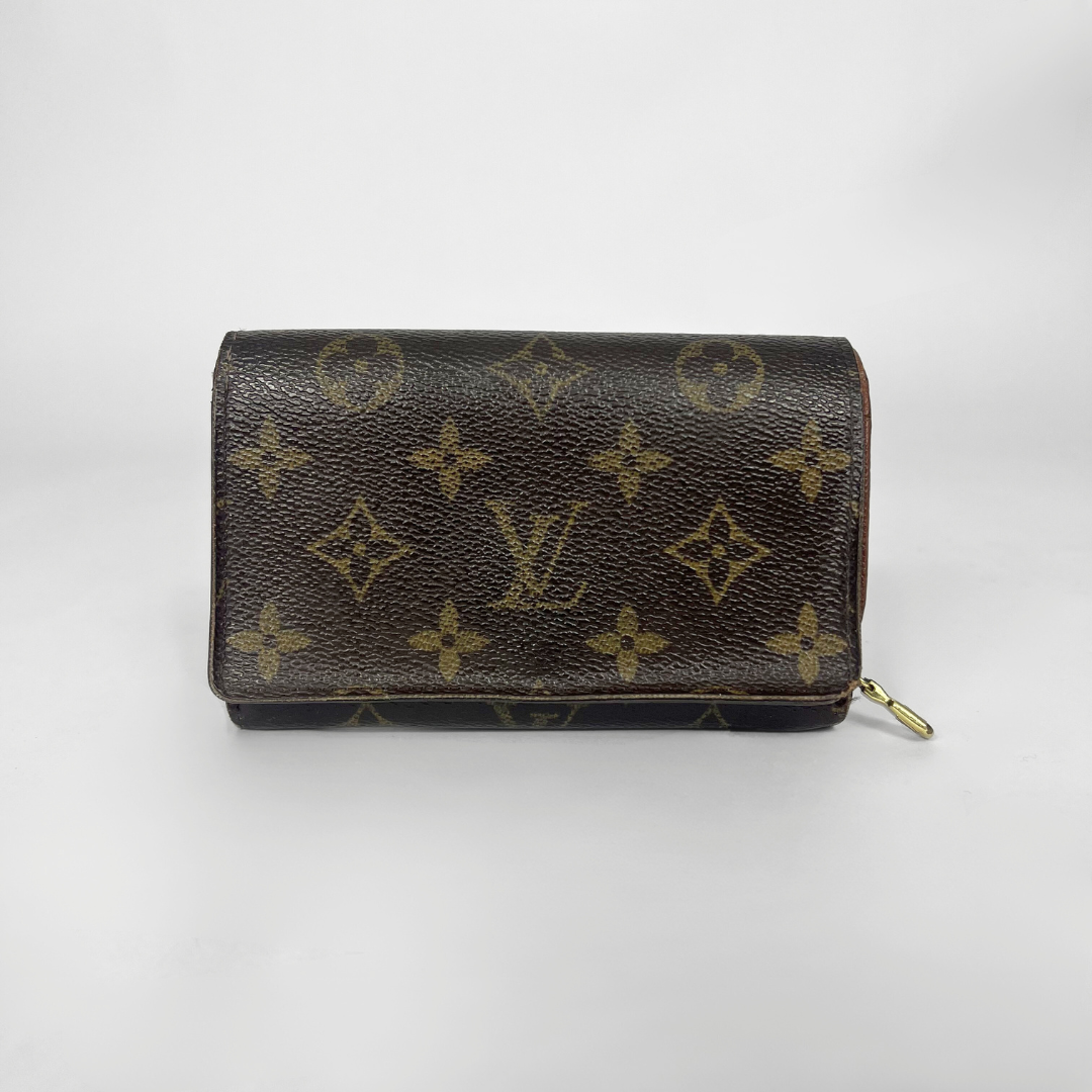 Louis Vuitton wallet with monogram pattern on a white background