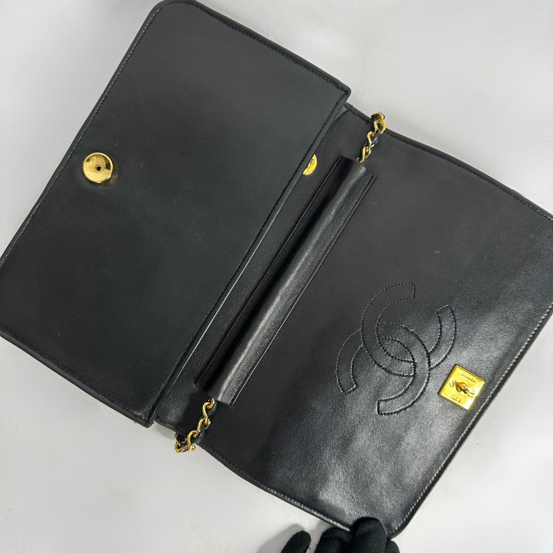 Black Chanel bag on white background