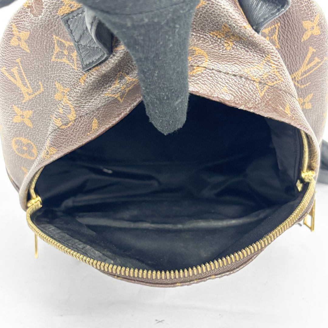 Louis Vuitton backpack with monogram pattern on a white background