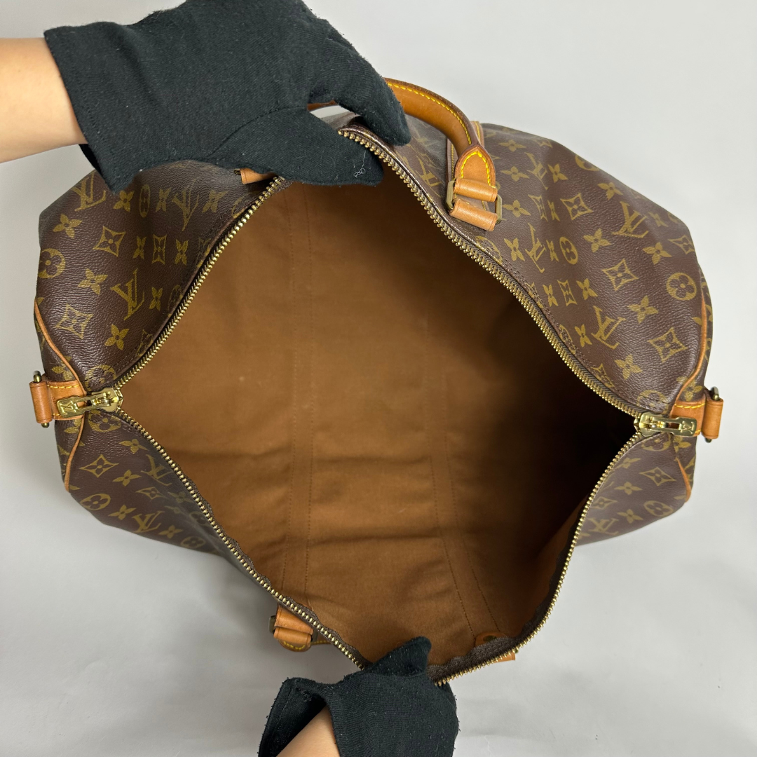 Louis Vuitton monogram bag with open top on a white background