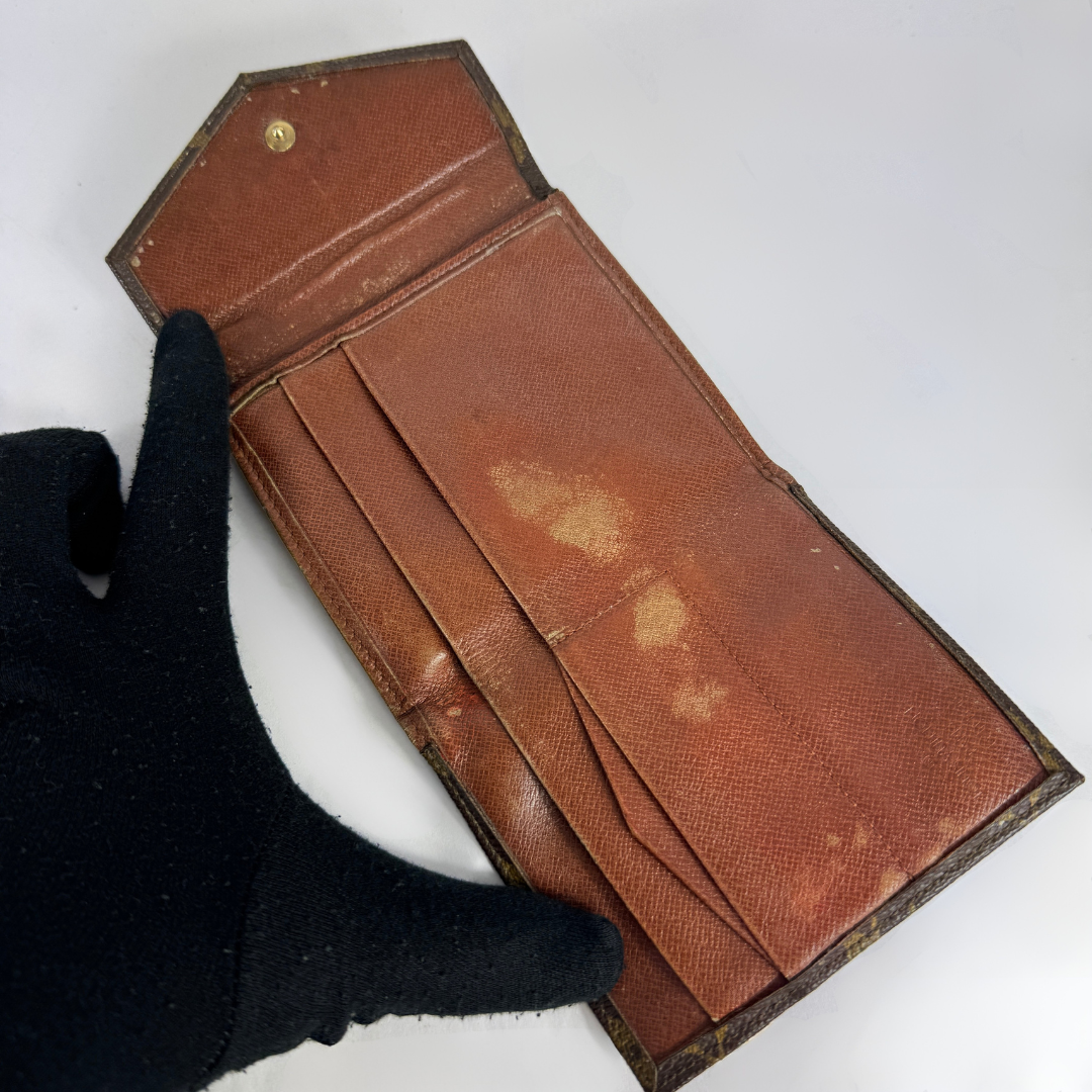 Louis Vuitton Druk Wallet on a white background