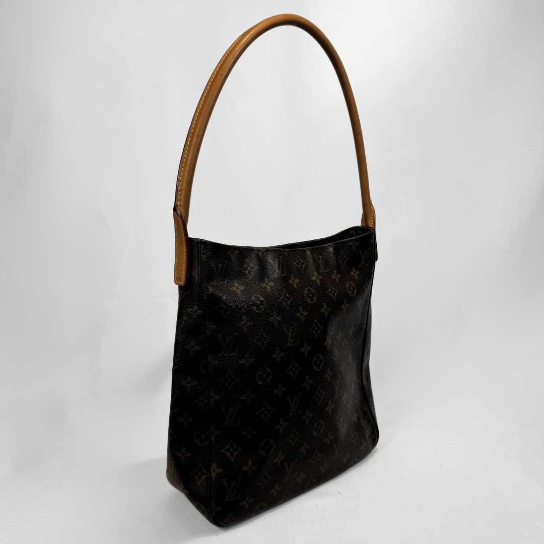A Louis Vuitton shoulder bag in dark brown monogram canvas with tan leather trim and handle, photographed against a light gray background.