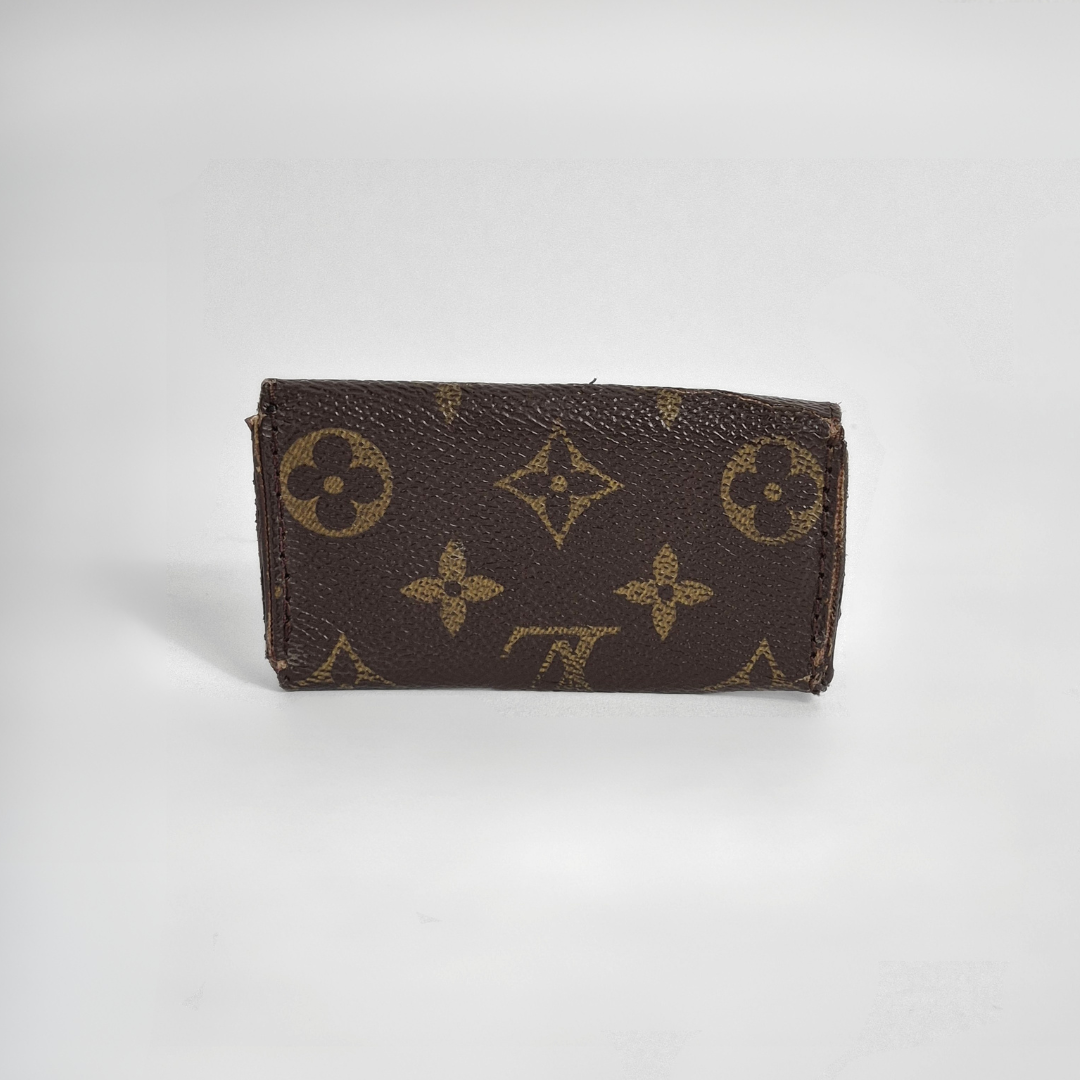 Louis Vuitton wallet with monogram pattern on white background