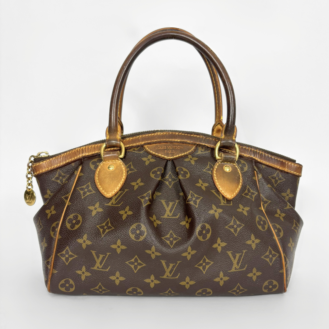 Brown handbag with gold accents on a white background