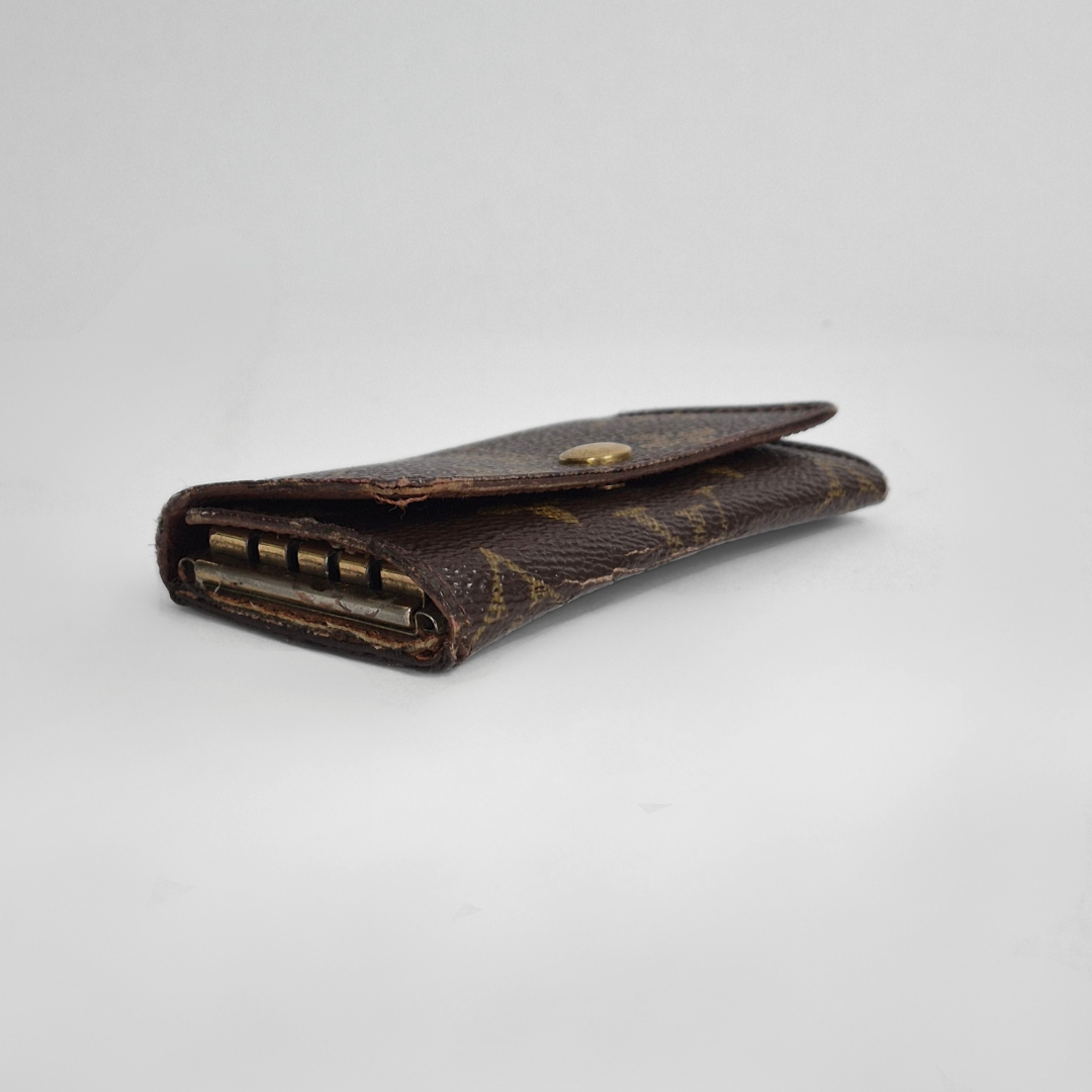 Louis Vuitton wallet with monogram pattern on white background