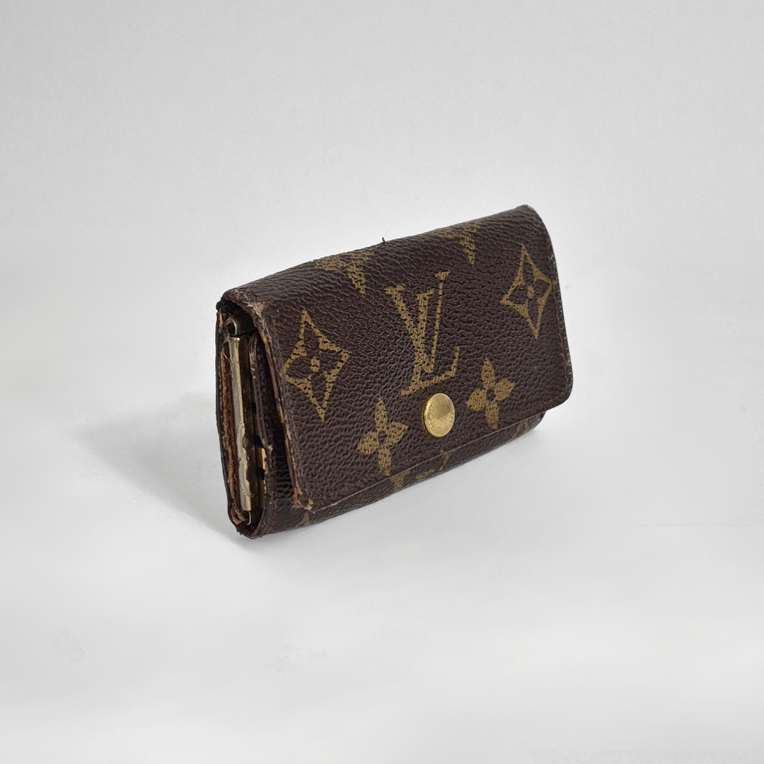 Louis Vuitton wallet with monogram pattern on white background