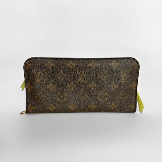 Louis Vuitton wallet with monogram pattern on a white background