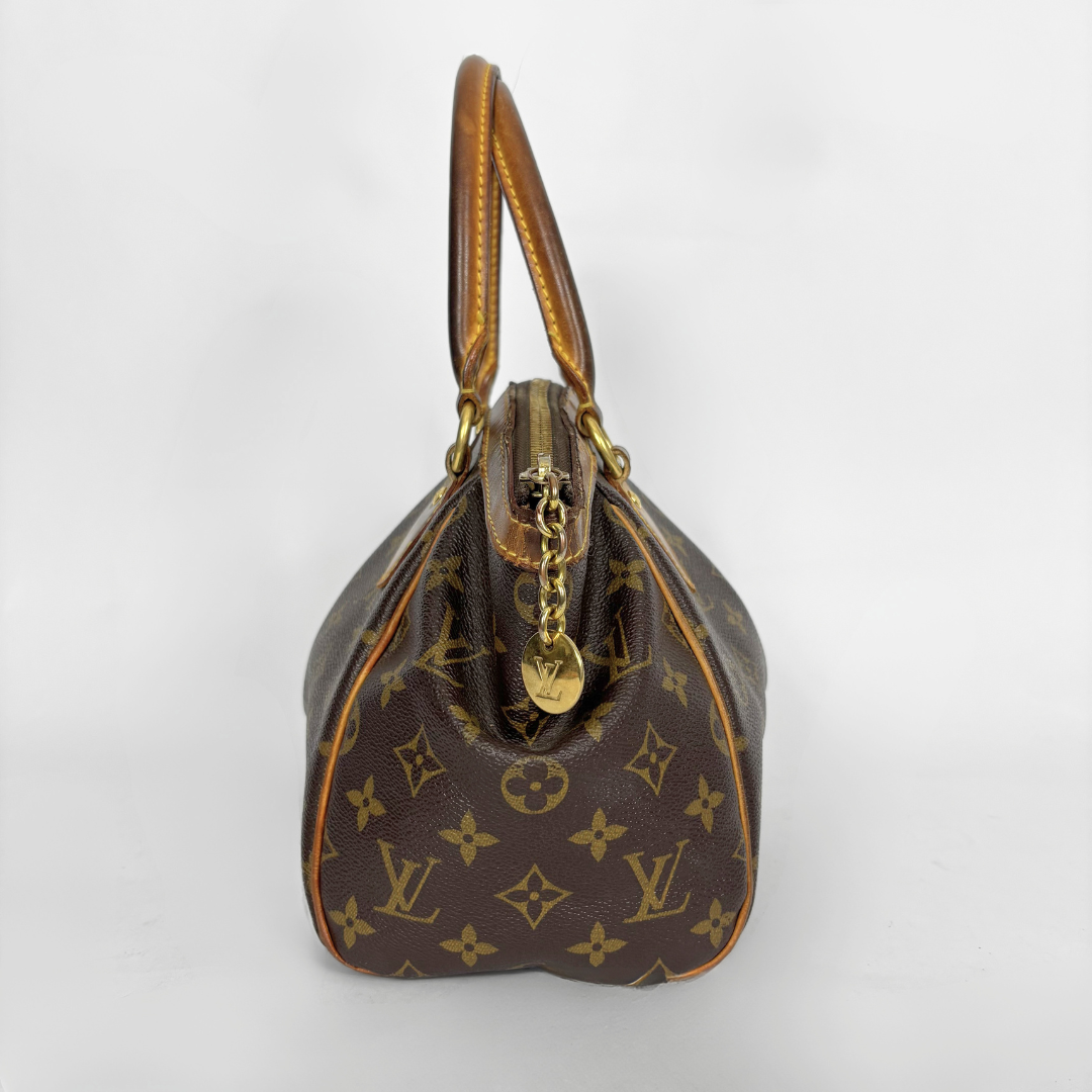 Brown handbag with gold accents on a white background