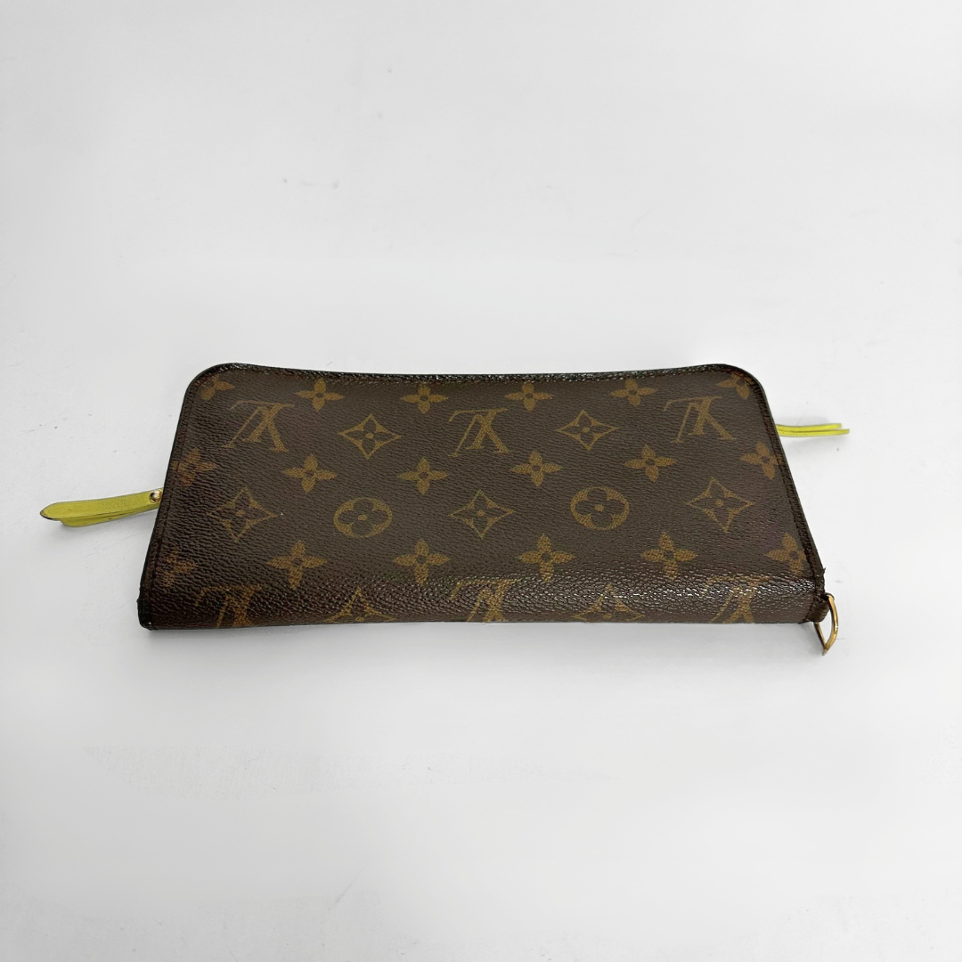 Designer wallet with monogram pattern on a white background