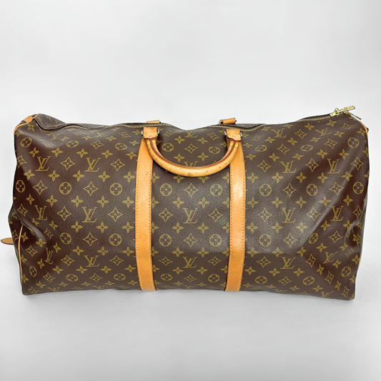Brown travel bag with yellow monogram pattern on a white background