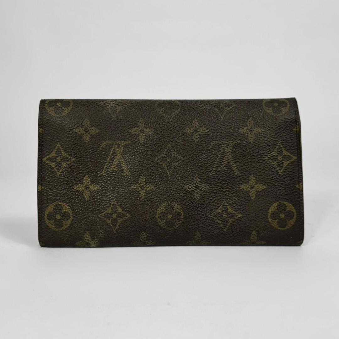 Brown wallet with gold monogram pattern on a white background