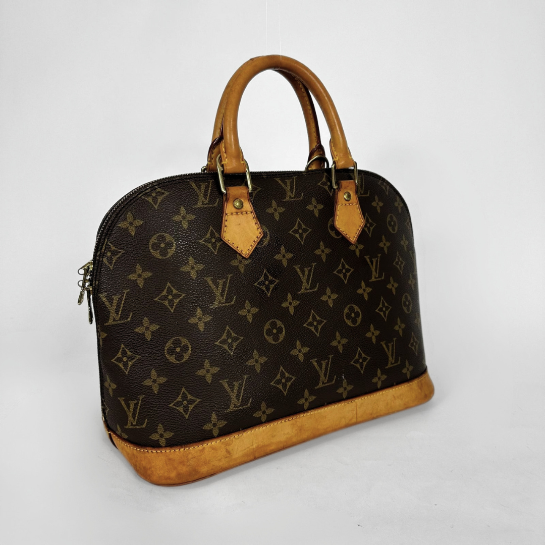 Louis Vuitton monogram canvas dome handbag with tan leather handles and trim, photographed on a light gray studio background.