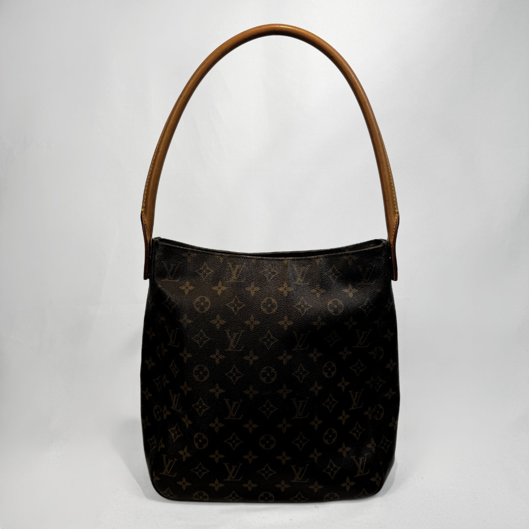 A Louis Vuitton monogram canvas shoulder bag with a brown leather handle, photographed against a light gray studio background.