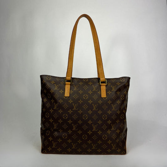 A Louis Vuitton monogram canvas tote bag with tan leather shoulder straps, photographed against a neutral light gray background.