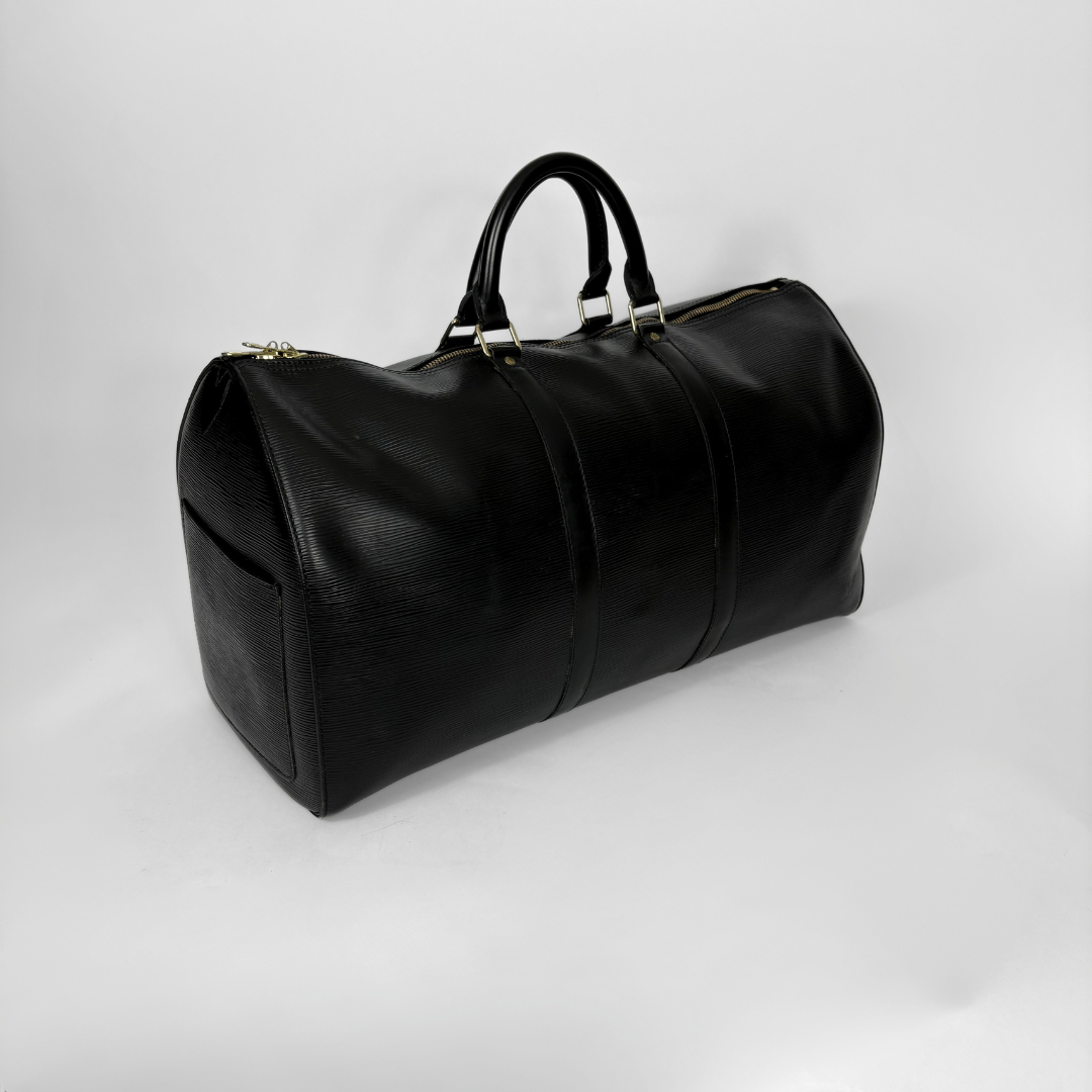 Black leather duffel bag on a light gray background