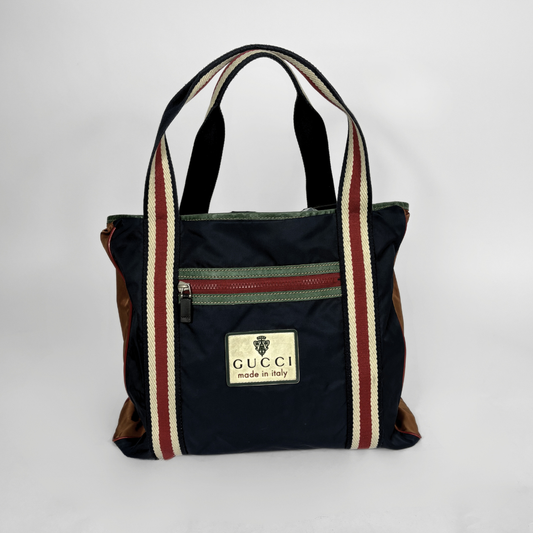 Gucci bag with striped handles on a white background
