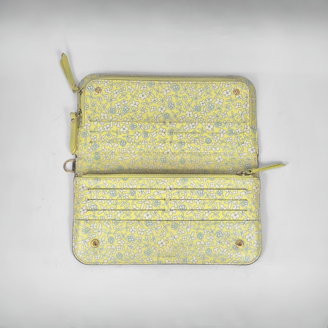 Floral patterned wallet with zippers on a light gray background