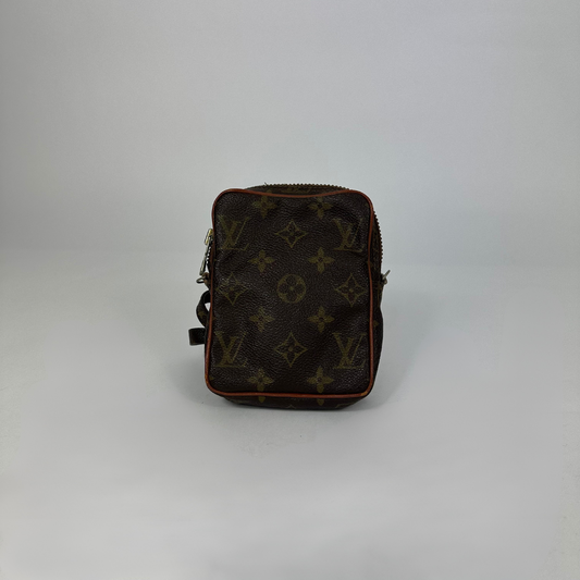 Black leather bag with brown monogram pattern on a white background